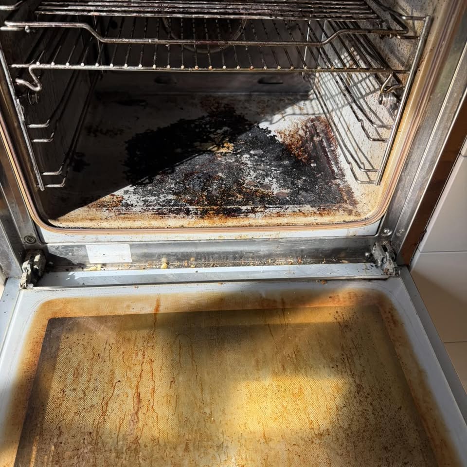 Before: an oven interior coated in burnt-on grease with stained door glass