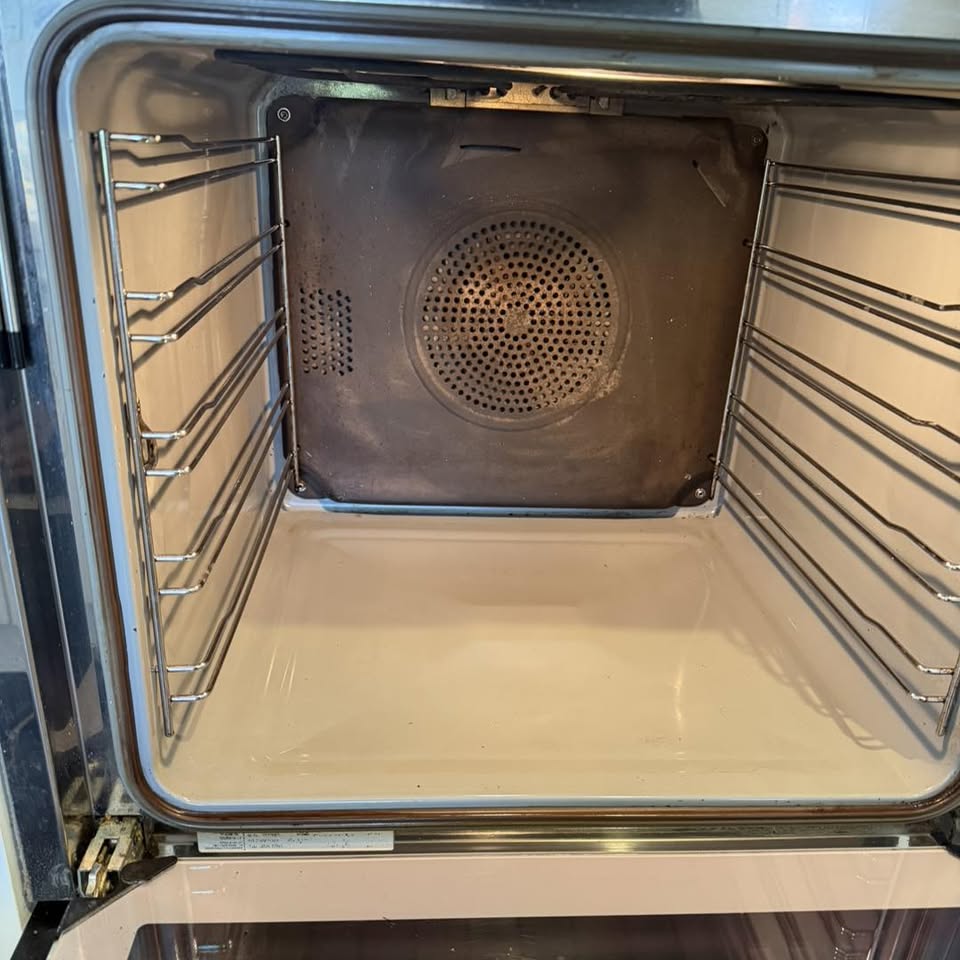After: the same white enamel oven interior restored to bright white