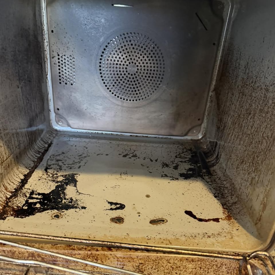 Before: a white enamel oven cavity splattered with old grease